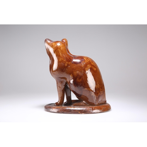 94 - A CANNEY HILL POTTERY CAT 19th Century, brown-glazed, seated on an integral oval plinth. 27cm highTh... 