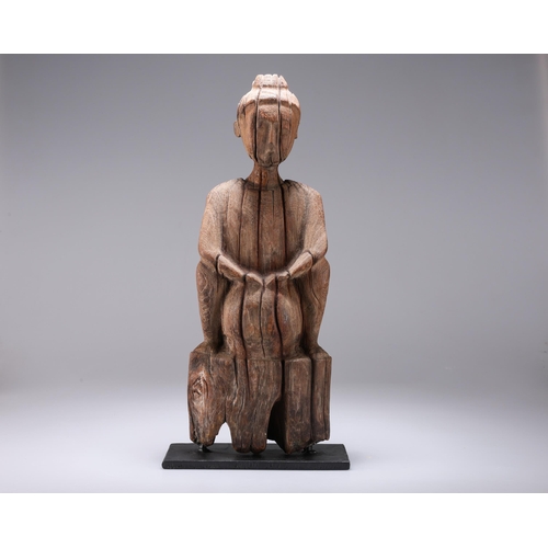 10 - A CARVED WOODEN FIGURE on a metal stand. 44cm high