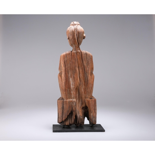 10 - A CARVED WOODEN FIGURE on a metal stand. 44cm high