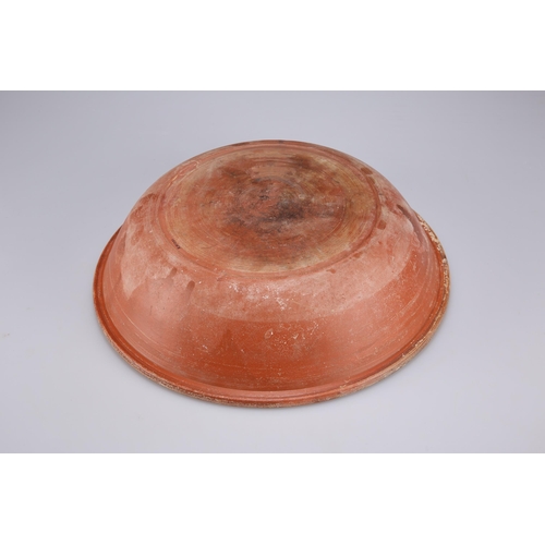 104 - A ROMAN TERRACOTTA REDWARE DISH, NORTH AFRICAN, CIRCA 3RD CENTURY an incised circle to the centre an... 