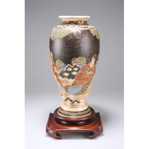 127 - A JAPANESE SATSUMA VASE, EARLY 20TH CENTURY of baluster form, decorated with figures, on a hardwood ... 