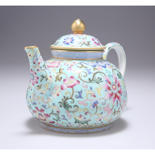 128 - A CHINESE FAMILLE ROSE TEAPOT the turquoise ground profusely enamel painted with scrolling tendrils,... 