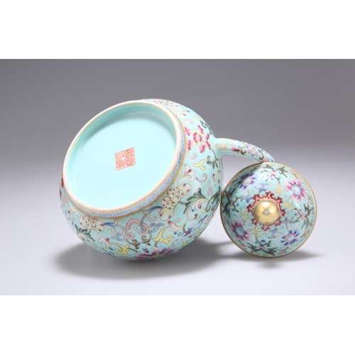 128 - A CHINESE FAMILLE ROSE TEAPOT the turquoise ground profusely enamel painted with scrolling tendrils,... 