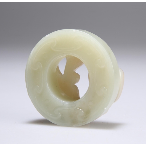 138 - A CHINESE CARVED JADE DISC with a feline-like creature. 5.3cm diameter