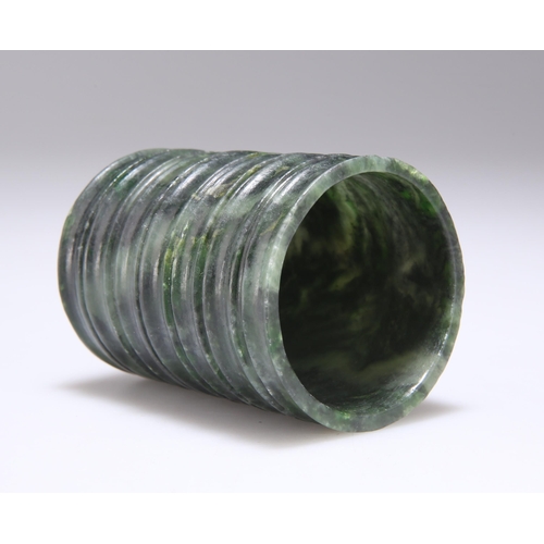 141 - A CHINESE CARVED SPINACH JADE BRUSH POT cylindrical form, turned ribbed body. 7.5cm high, 5.5cm diam... 