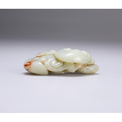 147 - A CHINESE JADE CARVING with scrolling tendrils, ruyi heads and a bat. 9cm wide