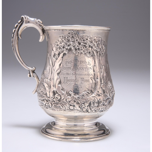 216 - A VICTORIAN SILVER MUG by Robert Harper, London 1871, of baluster form, chased with two figures hold... 