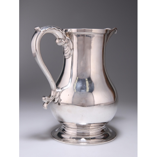 307 - AN ELIZABETH II SILVER BEER JUG by Wakely & Wheeler, London 1972, plain baluster form, the beak-... 