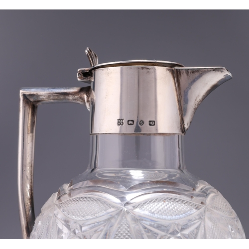 338 - A VICTORIAN SILVER-MOUNTED CLARET JUG by T Harwood & Son, Birmingham 1892, the bulbous cut-glass... 