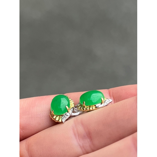 415 - A PAIR OF BI-COLOUR JADE AND DIAMOND EARRINGS oval jade within bi-colour fancy frames with diamond a... 