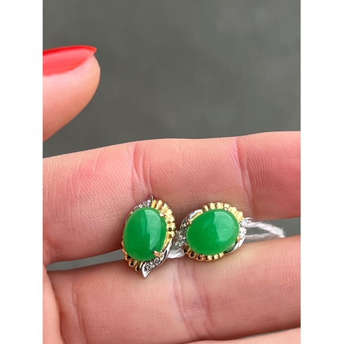 415 - A PAIR OF BI-COLOUR JADE AND DIAMOND EARRINGS oval jade within bi-colour fancy frames with diamond a... 