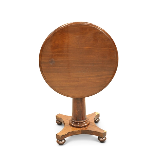 737 - A REGENCY MAHOGANY TILT-TOP CENTRE TABLE the moulded circular top raised on a substantial gun-barrel... 