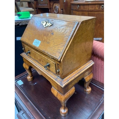 884 - AN 18TH CENTURY STYLE OAK MINIATURE BUREAU with fitted interior and drawer, raised on an integral st... 