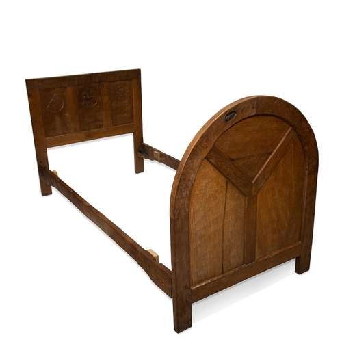 891 - ROBERT THOMPSON OF KILBURN, AN EARLY MOUSEMAN OAK SINGLE BED, CIRCA 1930S the three-panel headboard ... 