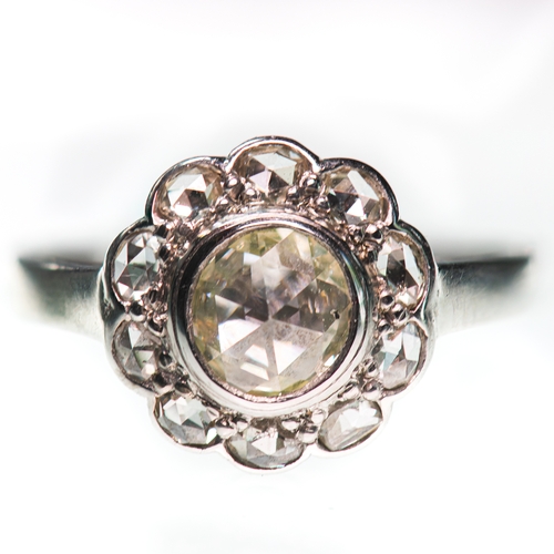 437 - A ROSE-CUT DIAMOND CLUSTER RING a rose-cut diamond within a border of further rose-cut diamonds. Unm... 