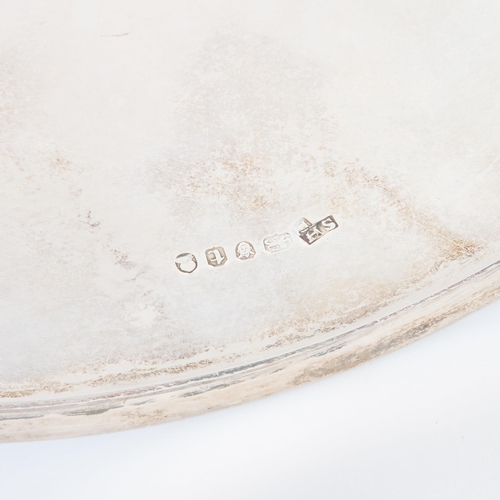 186 - A GEORGE III SILVER SALVER mark of Solomon Hougham overstriking, London 1794, plain circular form, w... 