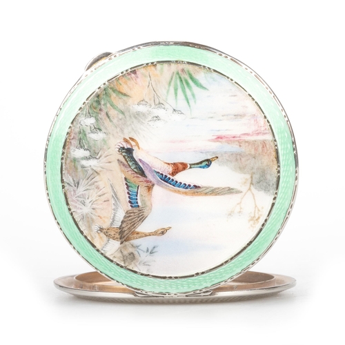 191 - A GEORGE V SILVER AND ENAMEL COMPACT by Henry Clifford Davis, Birmingham 1937, painted depicting mal... 