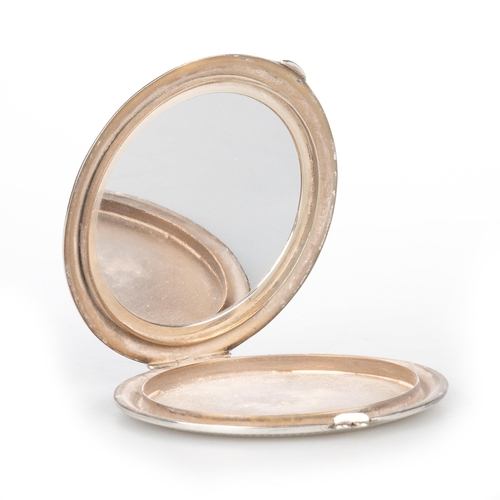 191 - A GEORGE V SILVER AND ENAMEL COMPACT by Henry Clifford Davis, Birmingham 1937, painted depicting mal... 