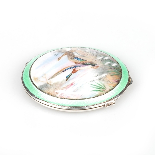 191 - A GEORGE V SILVER AND ENAMEL COMPACT by Henry Clifford Davis, Birmingham 1937, painted depicting mal... 