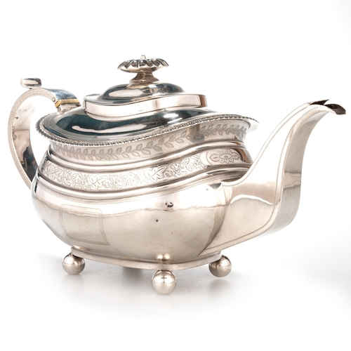 201 - § A GEORGE III SILVER TEAPOT probably by Naphtali Hart, London 1815, engraved with vine leaf frieze ... 