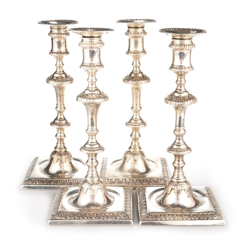 212 - A SET OF FOUR GEORGE III CAST SILVER CANDLESTICKS by Ebenezer Coker, London 1771, each detachable no... 