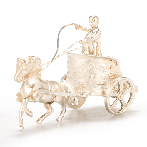 215 - A PAIR OF ELIZABETH II SILVER MODELS OF CHARIOTEERS maker S M D, London 1967 and 1968. (2) 8.5cm lon... 