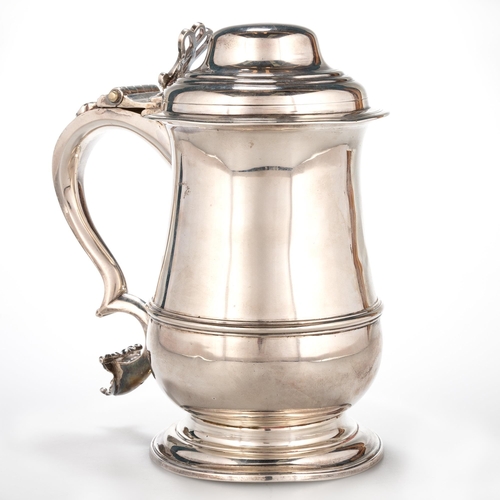 227 - AN EARLY GEORGE III SILVER LIDDED TANKARD maker I*M, London 1765, of baluster form, the hinged domed... 