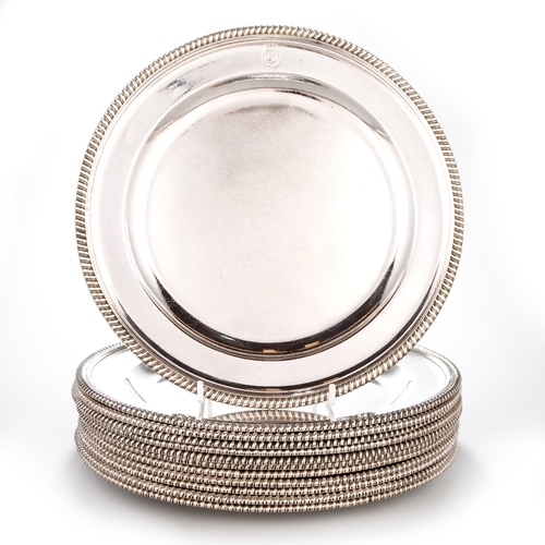 230 - A SET OF TWELVE GEORGE III SILVER DINNER PLATES by James Young, London 1791, circular with gadrooned... 