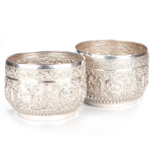 238 - A LARGE PAIR OF BURMESE SILVER BOWLS c.1910, circular, each chased with dancing figures, a band of s... 