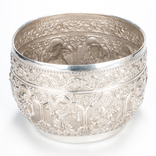 238 - A LARGE PAIR OF BURMESE SILVER BOWLS c.1910, circular, each chased with dancing figures, a band of s... 