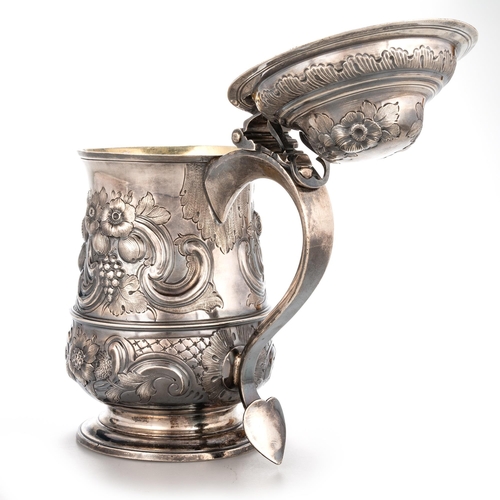 240 - A GEORGE III SILVER LIDDED TANKARD probably by William Collings, London 1778, of baluster form, the ... 