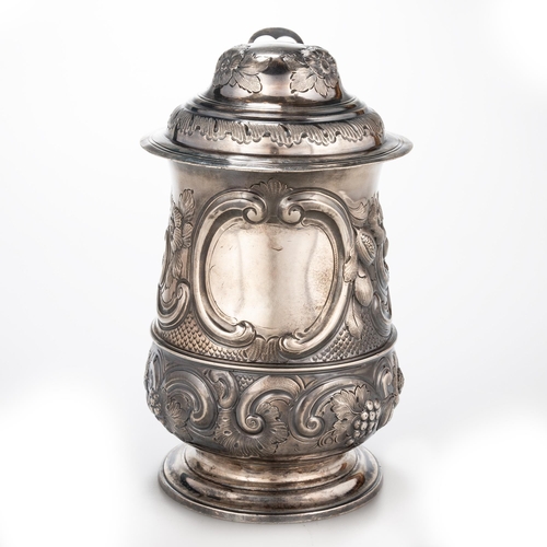 240 - A GEORGE III SILVER LIDDED TANKARD probably by William Collings, London 1778, of baluster form, the ... 