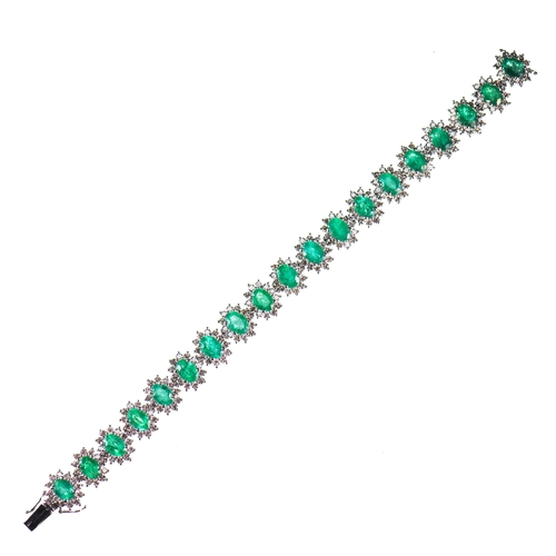 579 - AN EMERALD AND DIAMOND CLUSTER BRACELET oval-cut emeralds within borders of round brilliant-cut diam... 