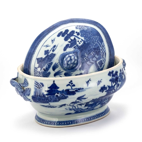 126 - A 19TH CENTURY NANKIN BLUE AND WHITE TUREEN AND COVER the shaped oval cover with a pineapple finial,... 