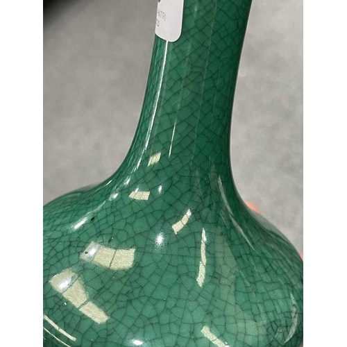 135 - A CHINESE GREEN CRACKLE-GLAZED VASE bottle-shaped, with a cafe-au-lait rim.13.5cm highIn very good c... 