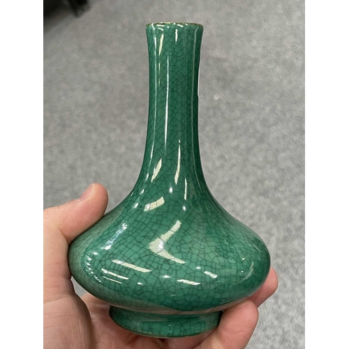 135 - A CHINESE GREEN CRACKLE-GLAZED VASE bottle-shaped, with a cafe-au-lait rim.13.5cm highIn very good c... 