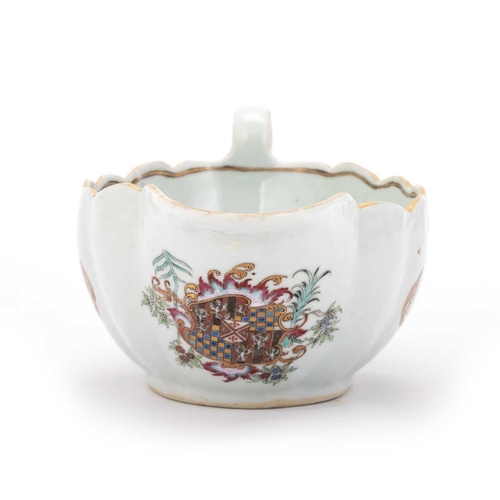 145 - A CHINESE ARMORIAL PORCELAIN SAUCEBOAT, QIANLONG, CIRCA 1745 of shaped oval form, painted to either ... 