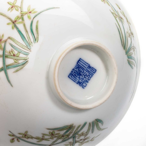 176 - A CHINESE BOWL circular, enamel painted with three flower sprays, bears an underglaze blue seal mark... 