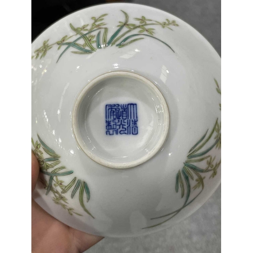 176 - A CHINESE BOWL circular, enamel painted with three flower sprays, bears an underglaze blue seal mark... 