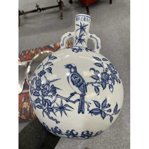 187 - A CHINESE BLUE AND WHITE MOON FLASK of oval section, painted with flower and bird compositions, the ... 