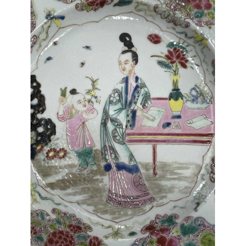 217 - A CHINESE FAMILLE ROSE PLATE circular, painted to the centre with two figures, the rim painted with ... 