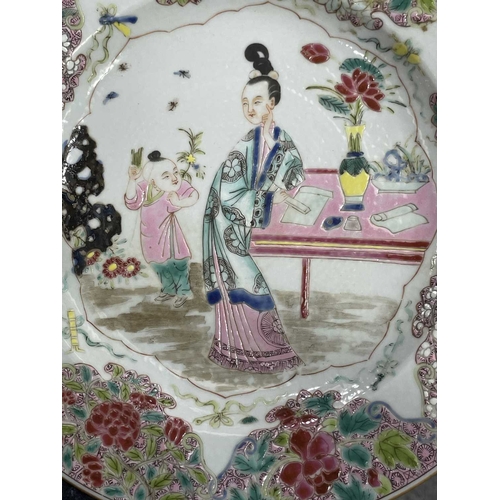 217 - A CHINESE FAMILLE ROSE PLATE circular, painted to the centre with two figures, the rim painted with ... 