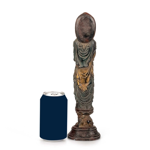 253 - A TIBETAN GILT AND PAINTED BRONZE FIGURE OF A BUDDHIST DEITY standing on a plinth supported by a myt... 