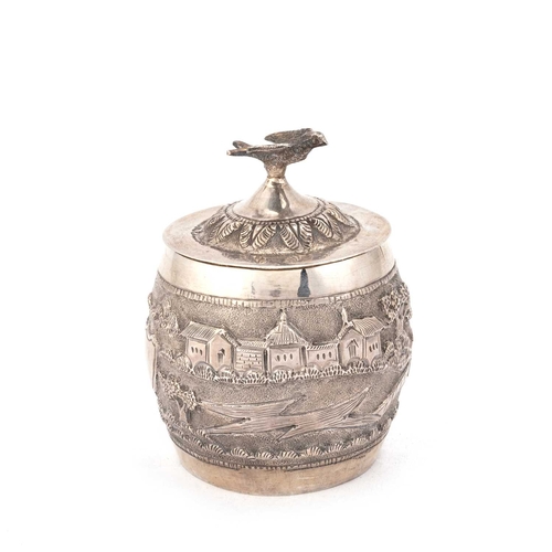 296 - AN INDIAN SILVER TEA CADDY unmarked, barrel-shaped, chased with a landscape, the cover with a bird f... 