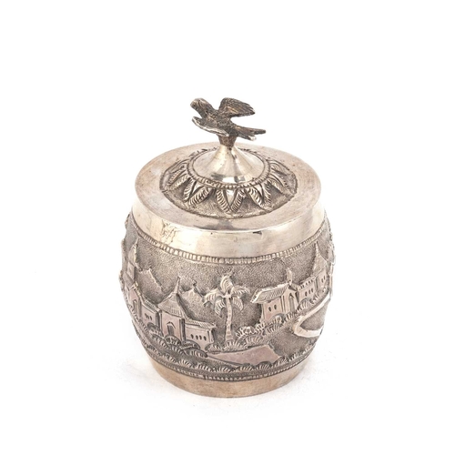 296 - AN INDIAN SILVER TEA CADDY unmarked, barrel-shaped, chased with a landscape, the cover with a bird f... 