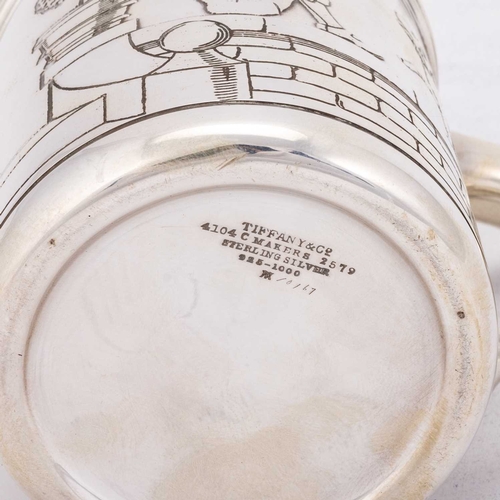 302 - TIFFANY & CO: AN ART DECO STERLING SILVER MUG by Tiffany & Co, circular form, decorated with a p... 