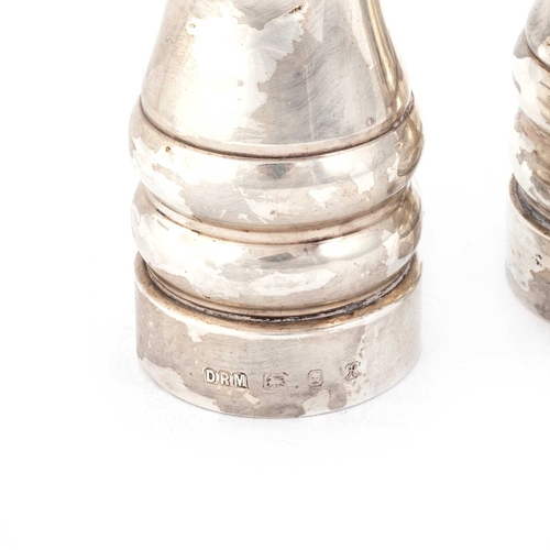 341 - A PAIR OF ELIZABETH II SILVER PEPPER GRINDERS by David R Mills, London 1982, of plain waisted form. ... 