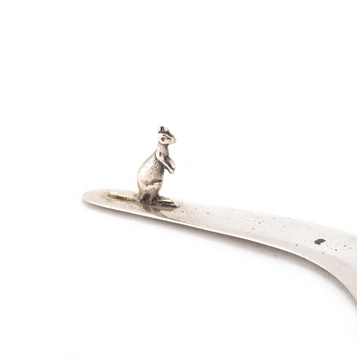 376 - A NOVELTY SILVER LETTER OPENER in the form of a boomerang, mounted with the figure of a kangaroo. 12... 