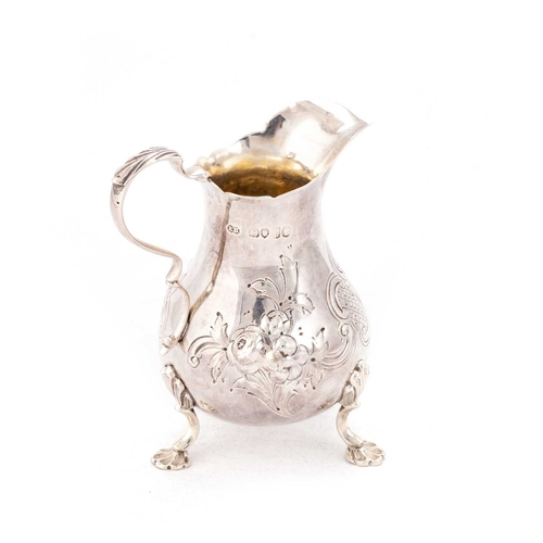 386 - A VICTORIAN SILVER CREAM JUG by Robert Harper, London 1865, chased with flowers, scrolls and diaper ... 