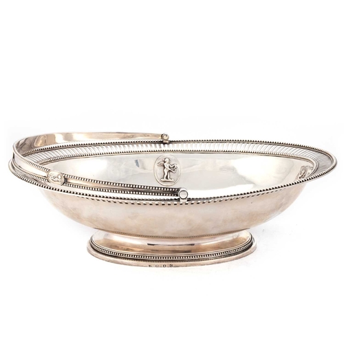 420 - A GEORGE III SILVER CAKE BASKET by Andrew Fogelberg, London 1778, with a beaded and pierced rim, the... 